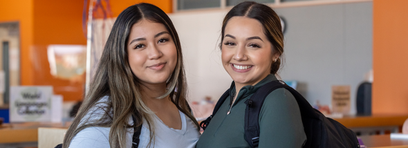 Two students smiling