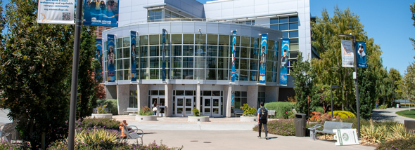 Student walking into building