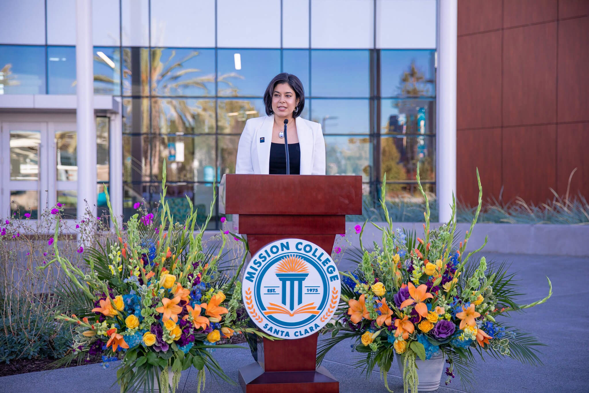 President Seher Awan speaking at a podium
