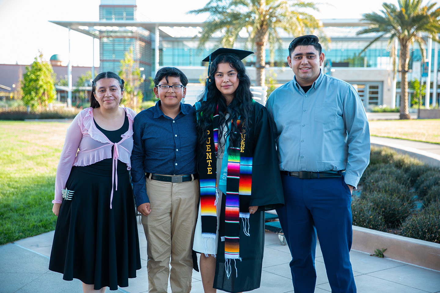 Mission College graduate with family