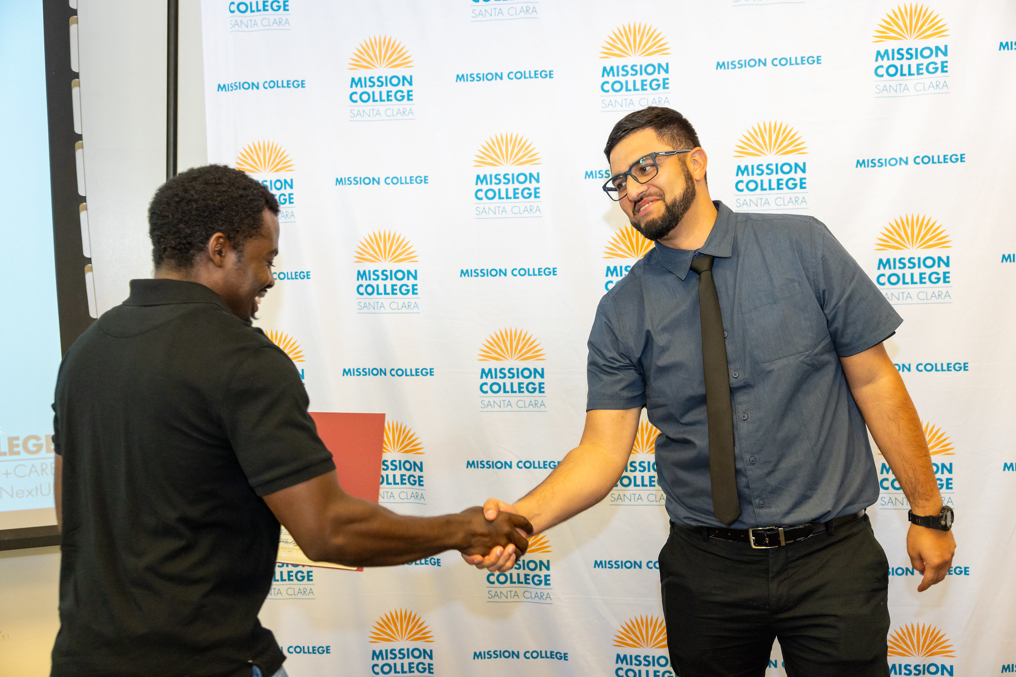 EOPS student getting certificate and shaking counselors hand