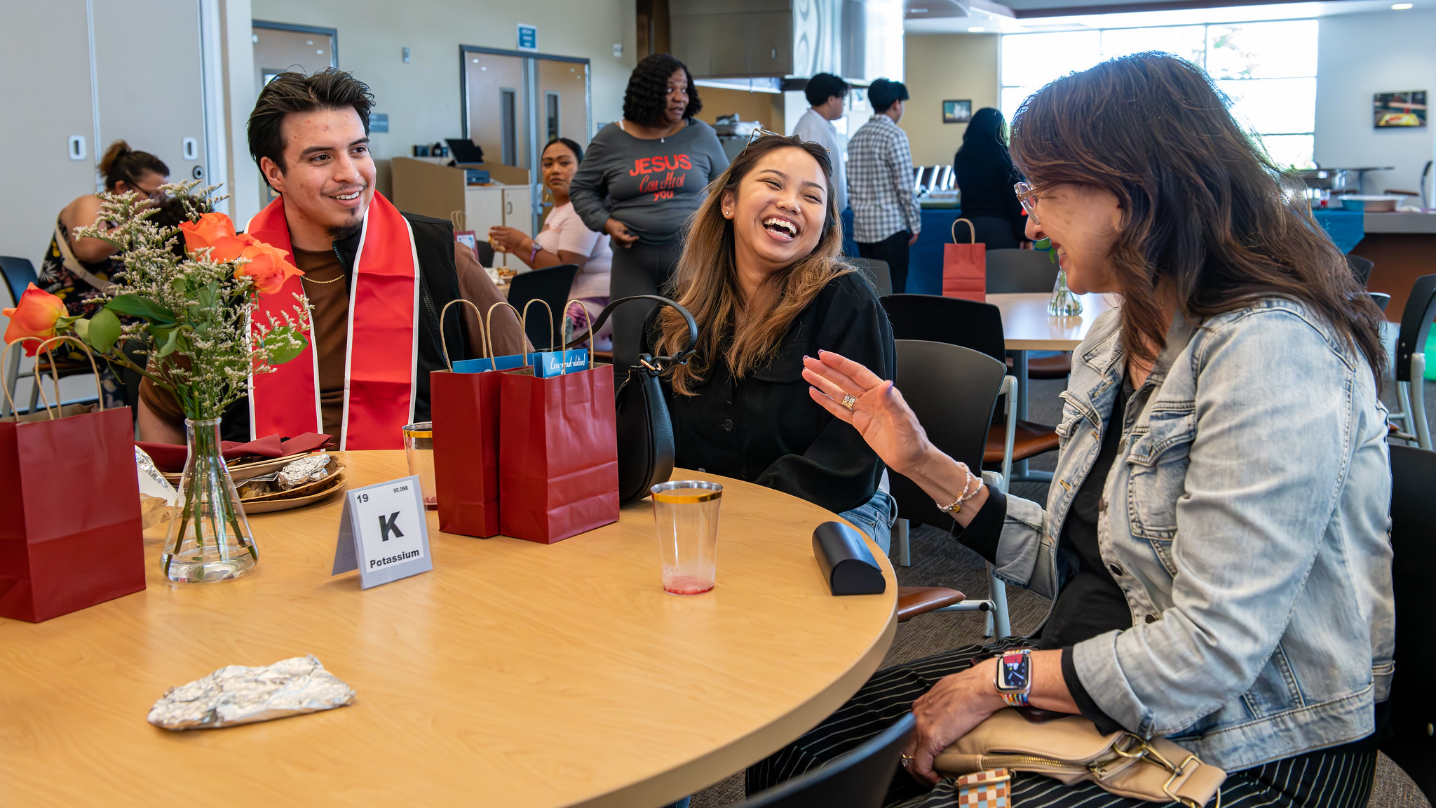 Students talking at table at Mesa anniversary event