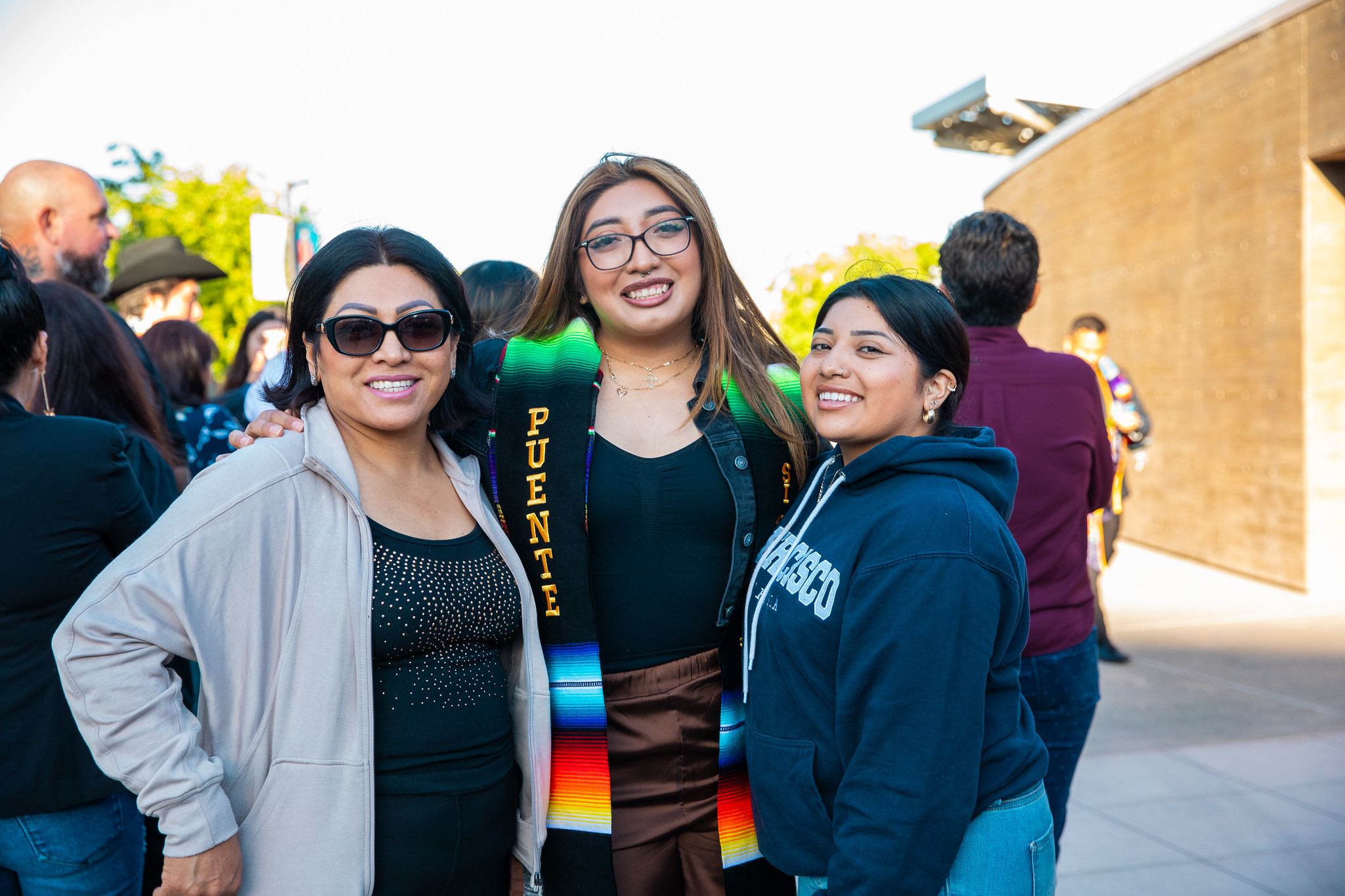 Graduates smiling in building